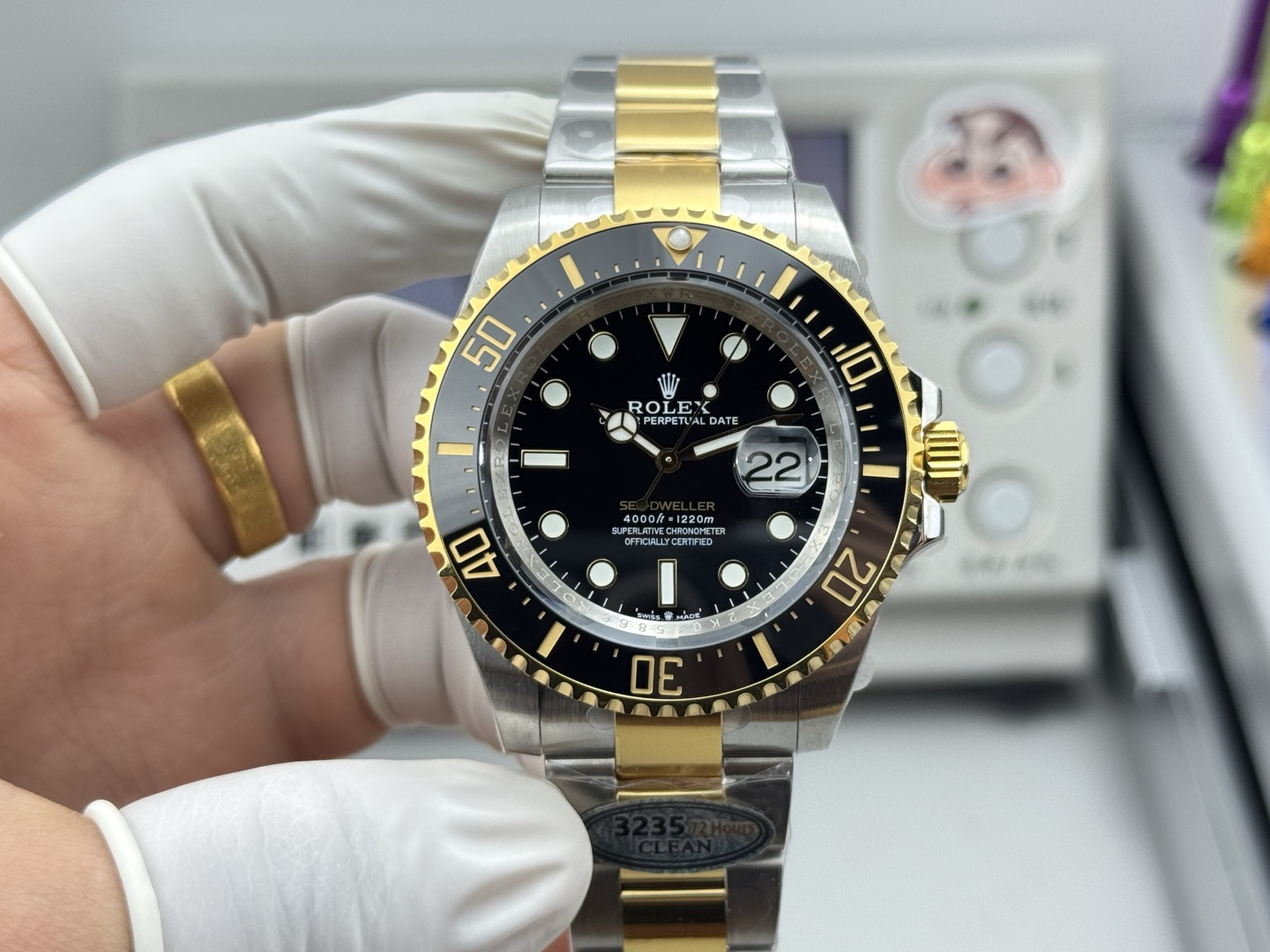 Two-tone replica Rolex Sea-Dweller dial with ceramic bezel and date magnifier